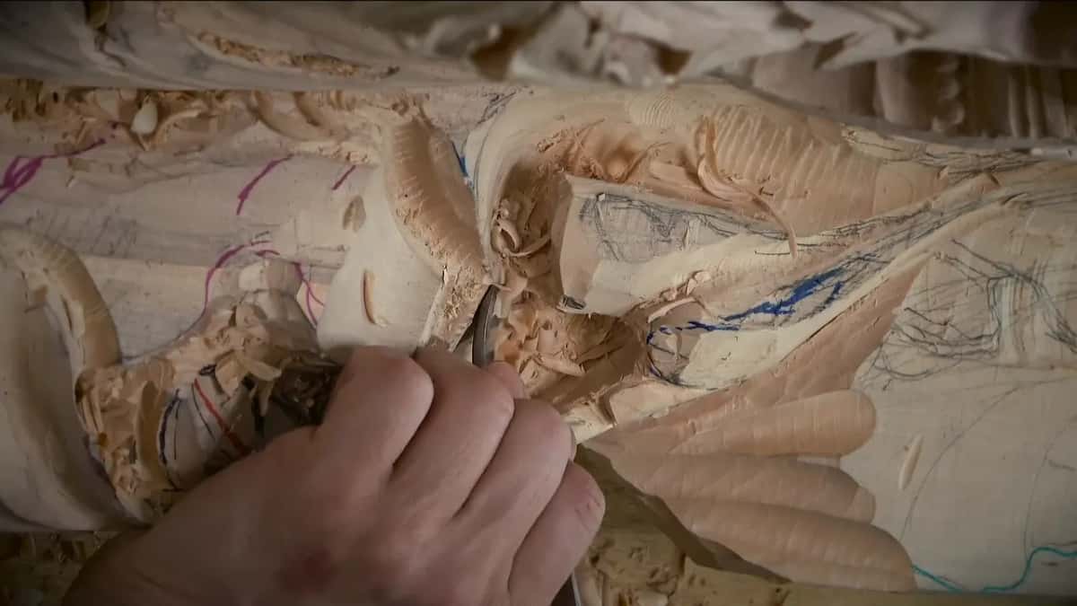 Hand close over a lobe, working inside a pencil outline