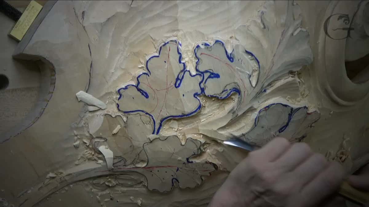 Lobed edges drawn in blue marker, the tip of a gouge at the lower right