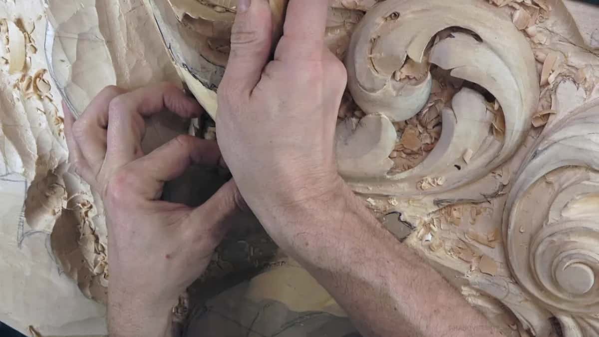 Two hands close together, a tiny tool between them.