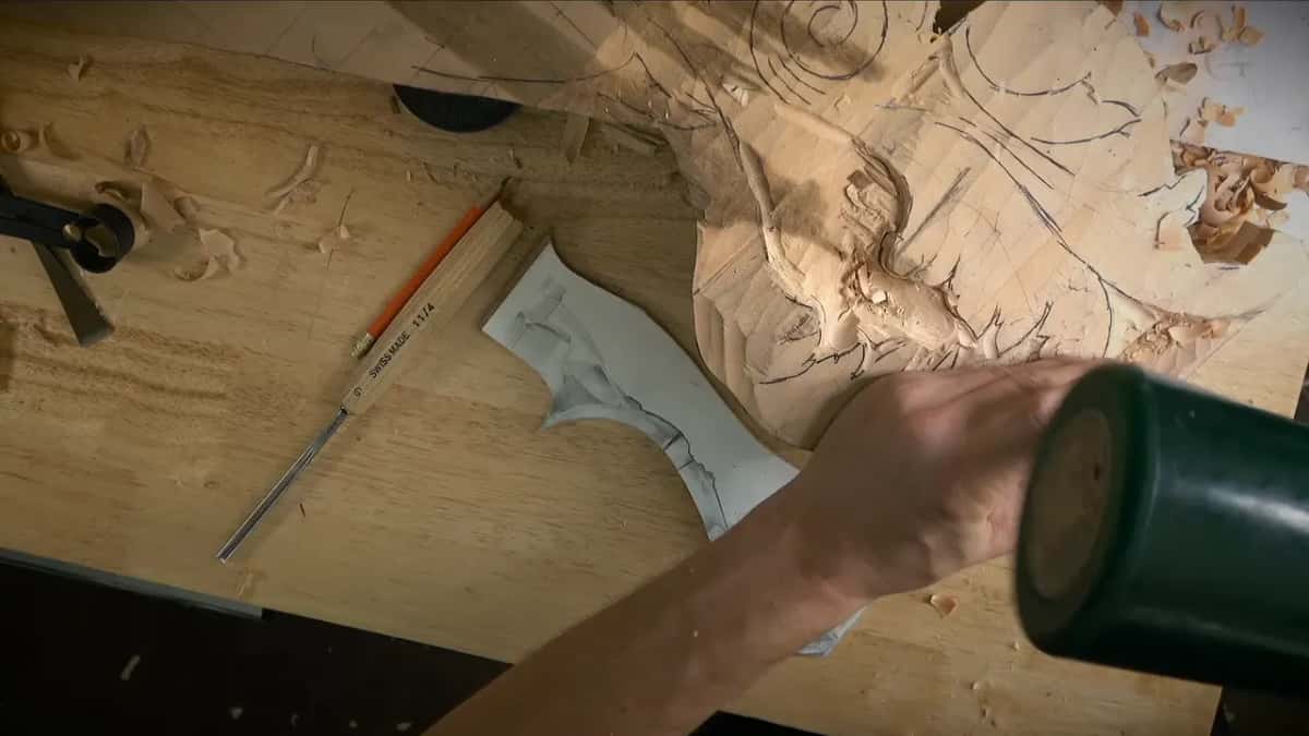 Mallet raised over the piece