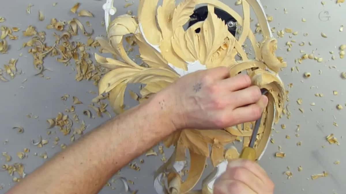 Chips pile up while two hands work