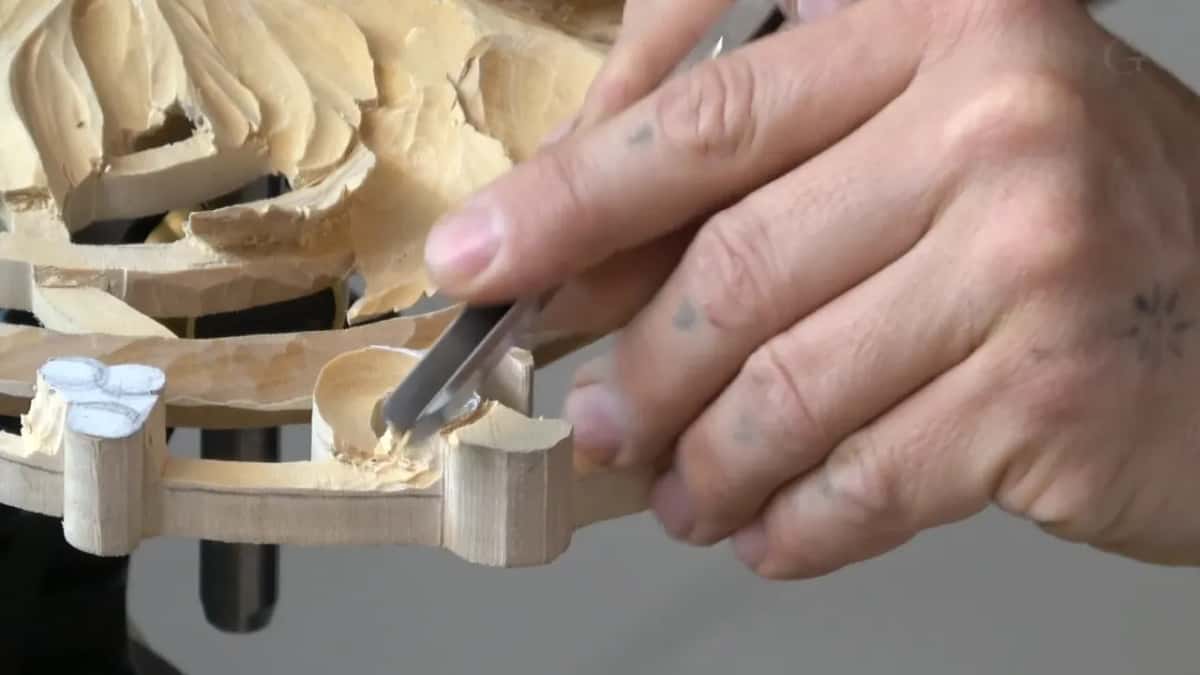 A narrow tool working down inside the volute's curl