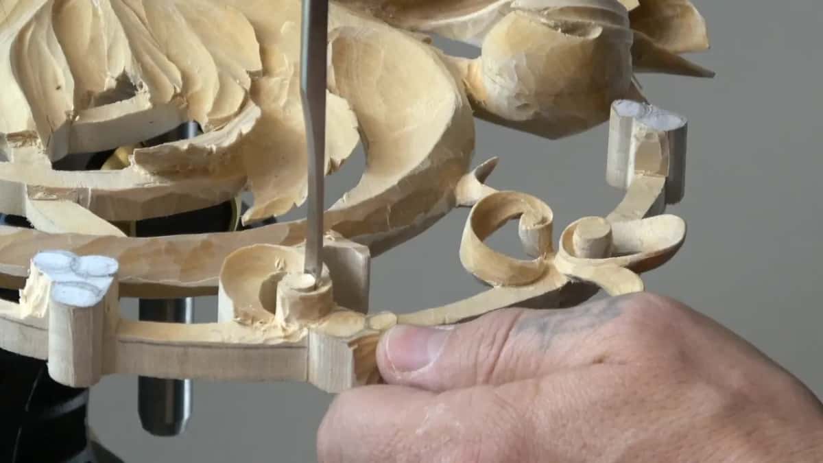 Tool held straight up, pressing into the middle of the curl, my thumb on the frame