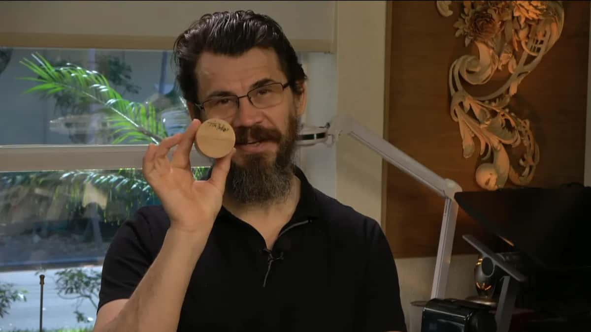 A tiny mallet, held up close to the camera.