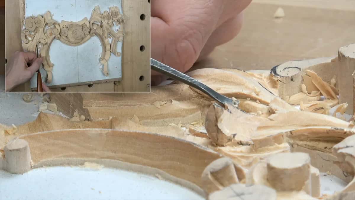 Fingertips guide a small curved tool over the molding near a carved scroll, top view inset