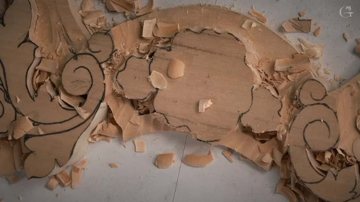 Ground lowered inside the curved band around a flower outline, with shavings still lying on it