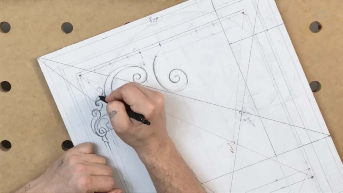 Panel turned at an angle on the bench while a black pencil adds to the corner leaves