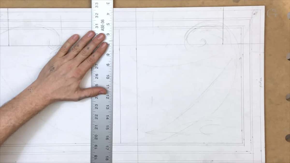 Panel carrying both borders and two sketched volutes, with a rule stood up the left hand side