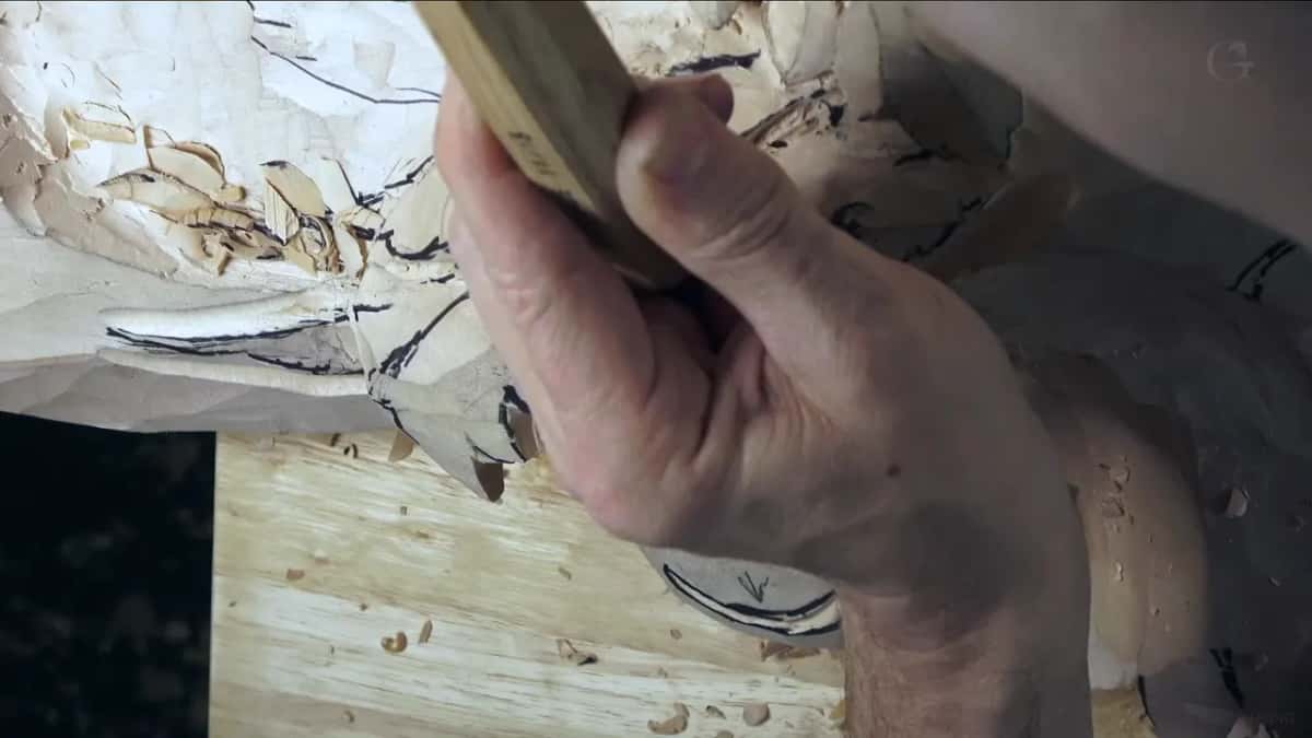 Knuckles over a gouge handle.