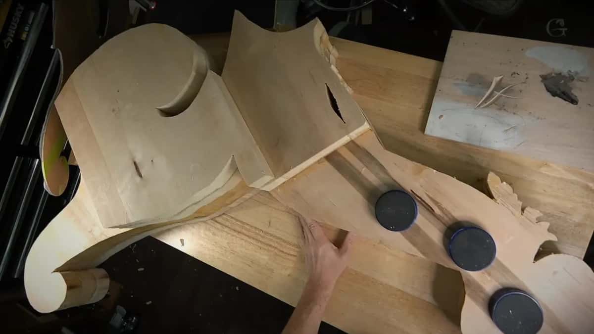 Three round black cookies sit on the board next to the scrolled end of the block