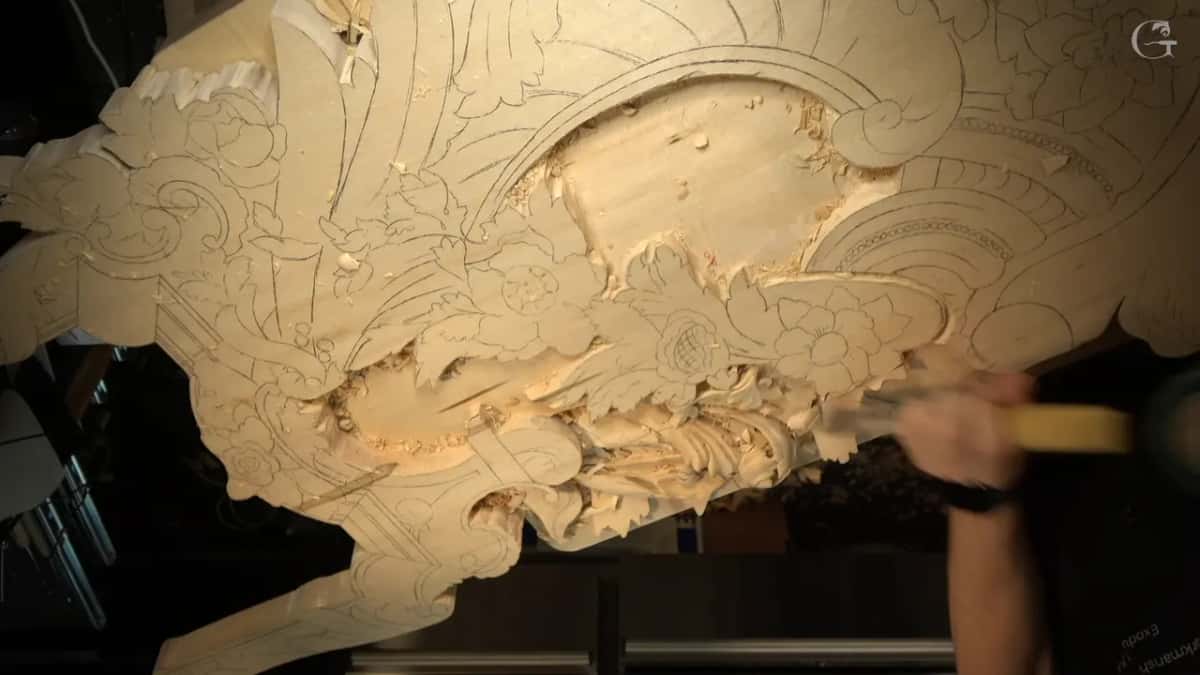 Whole board seen from far off, one arm reaching in with a long handled tool.