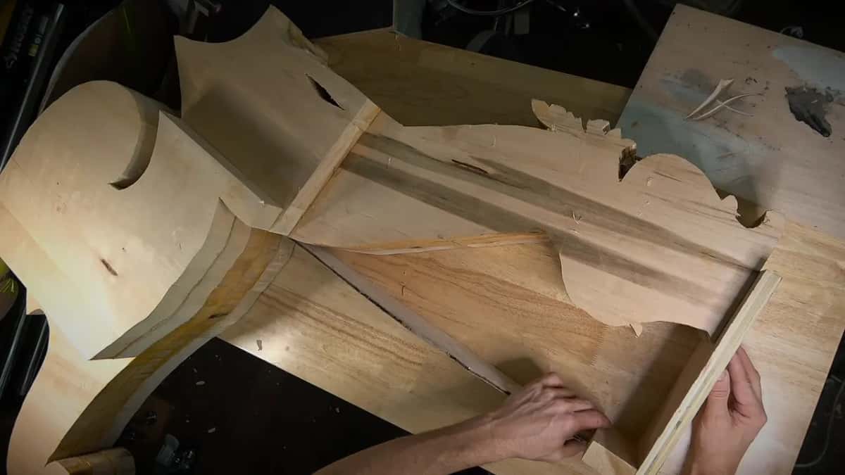 Pressing half of the print flat against the block beside a thin plywood strip