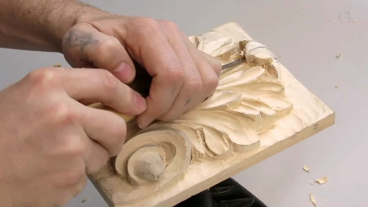 Two hands on one tool above the round curl
