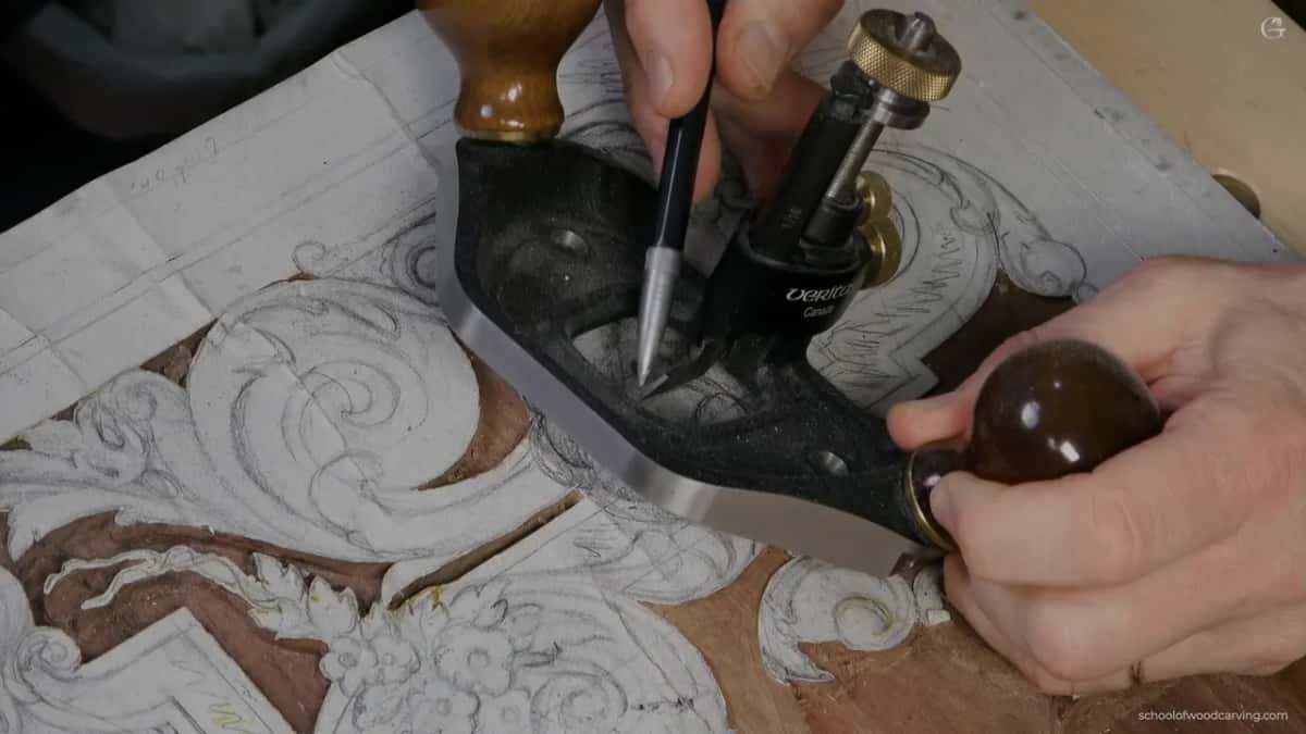 Pencil pointing at a black plane with two round wood knobs