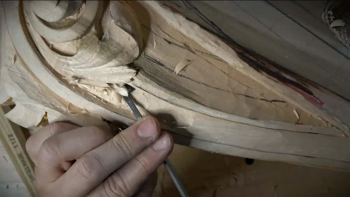 A slim tool held like a pen at the base of a leaf