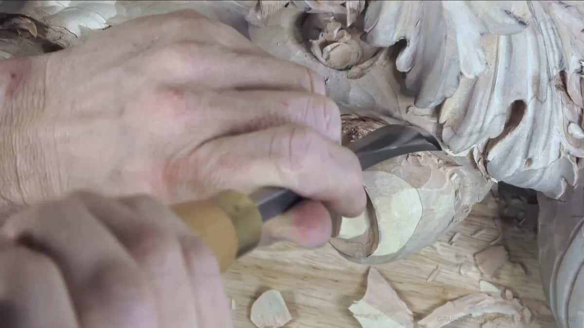 Yellow handle, both hands.