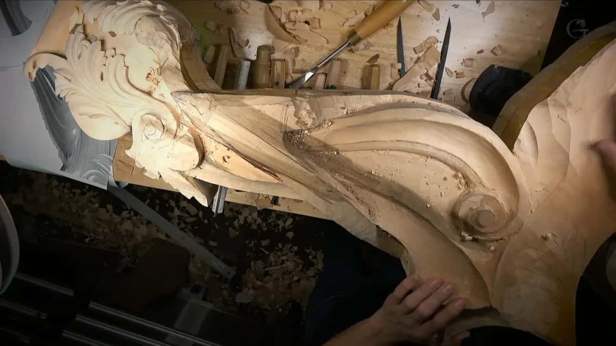 The same rough piece seen whole, one hand resting near the bottom of the frame