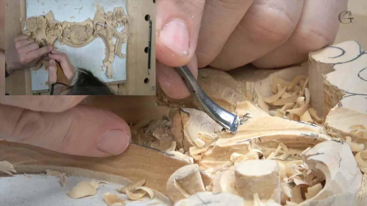 Bent-neck tool on the ridge, its shank bowed up away from the wood, with the panel in a corner inset