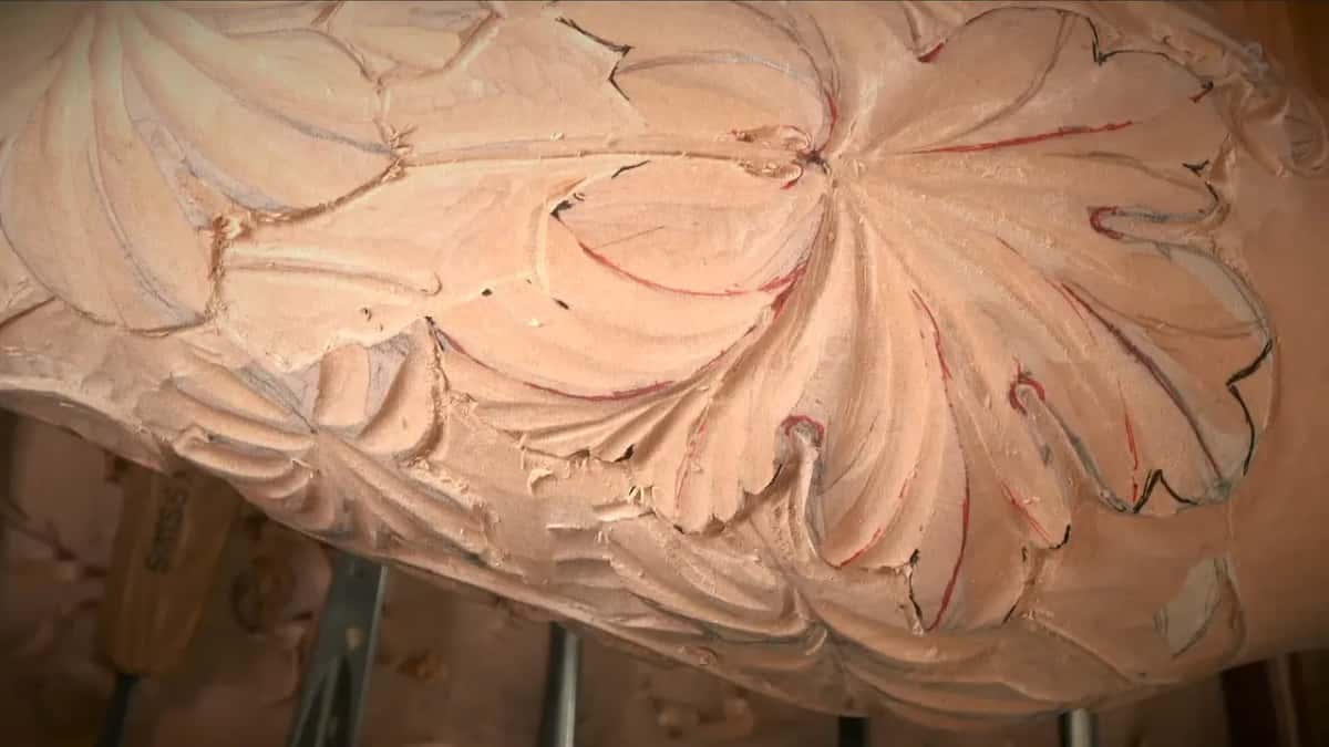 Close view of a carved leaf with red marker along the ridges and black ink around its edge