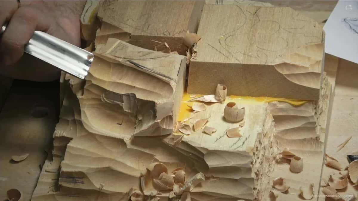 Shavings pile up on the lower step as a large gouge slides flat across the top corner