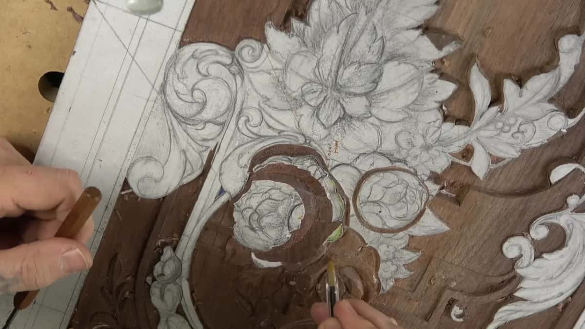 Tool working beside a carved flower